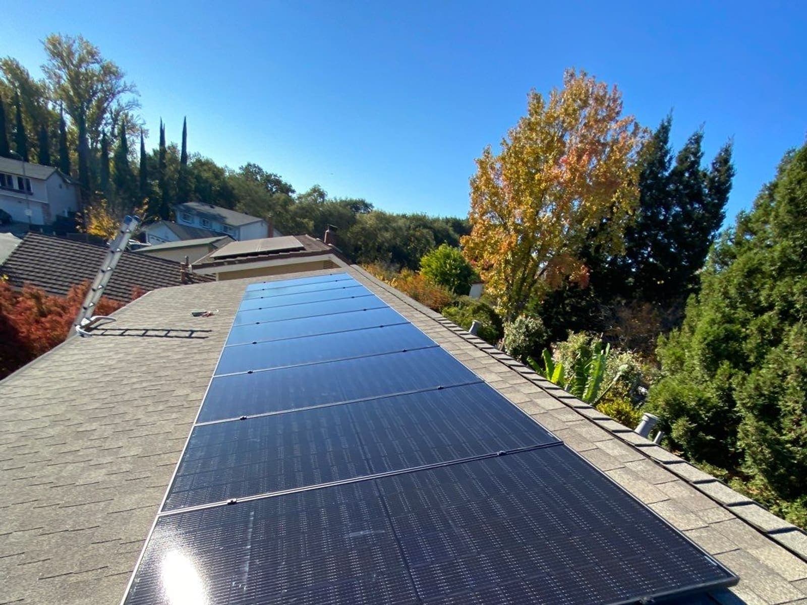 A single long run of solar panels along the full length of a roof plane