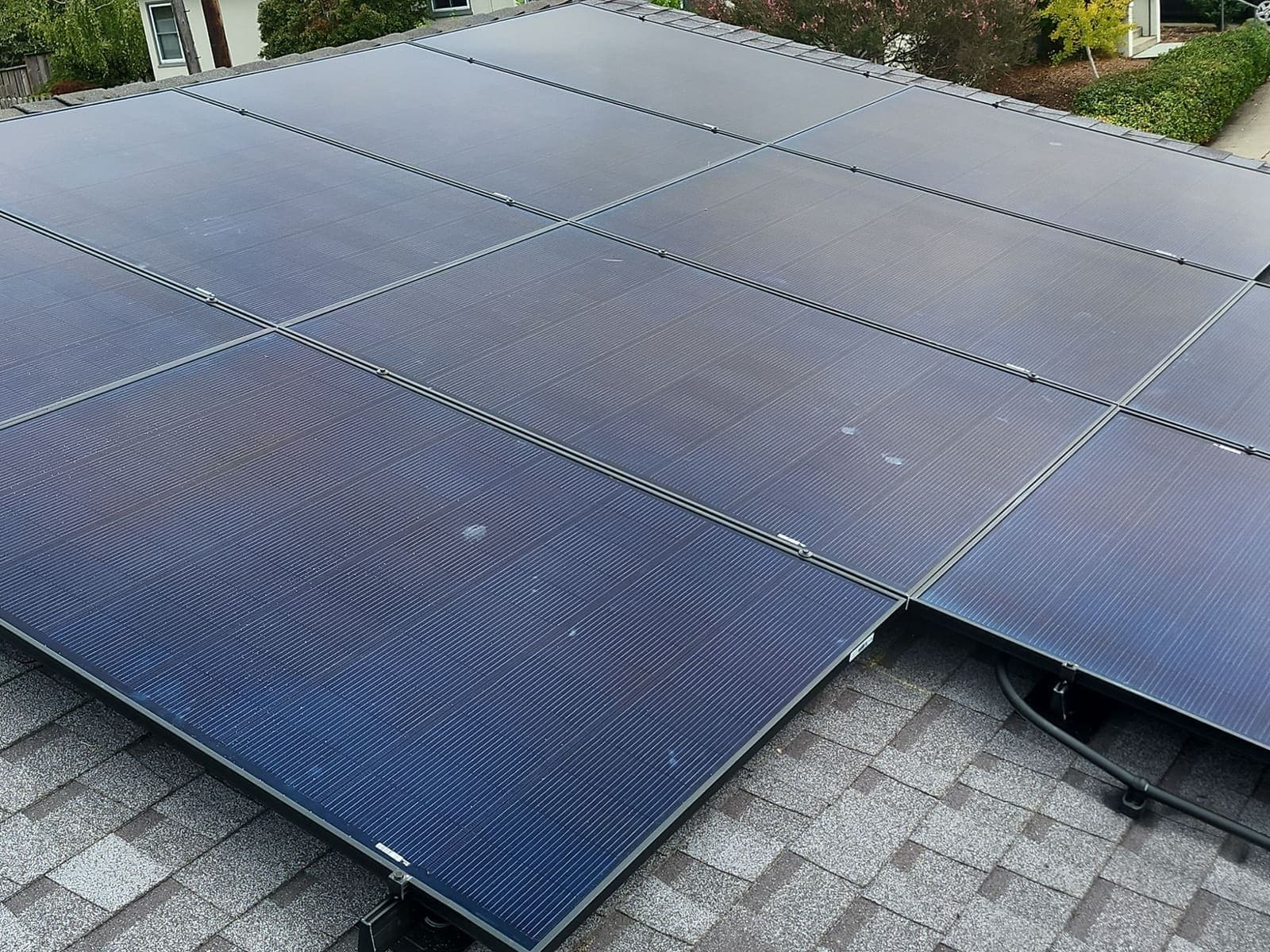 Solar panels installed across two adjoining roof planes either side of a ridge